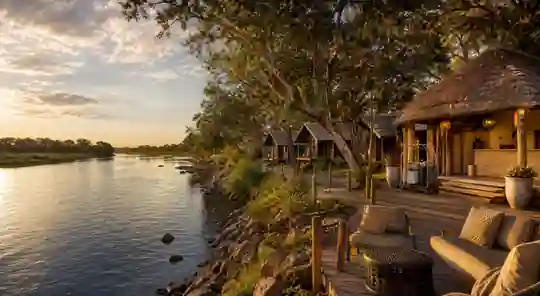 Riverside lodge with guest chalets at sunset